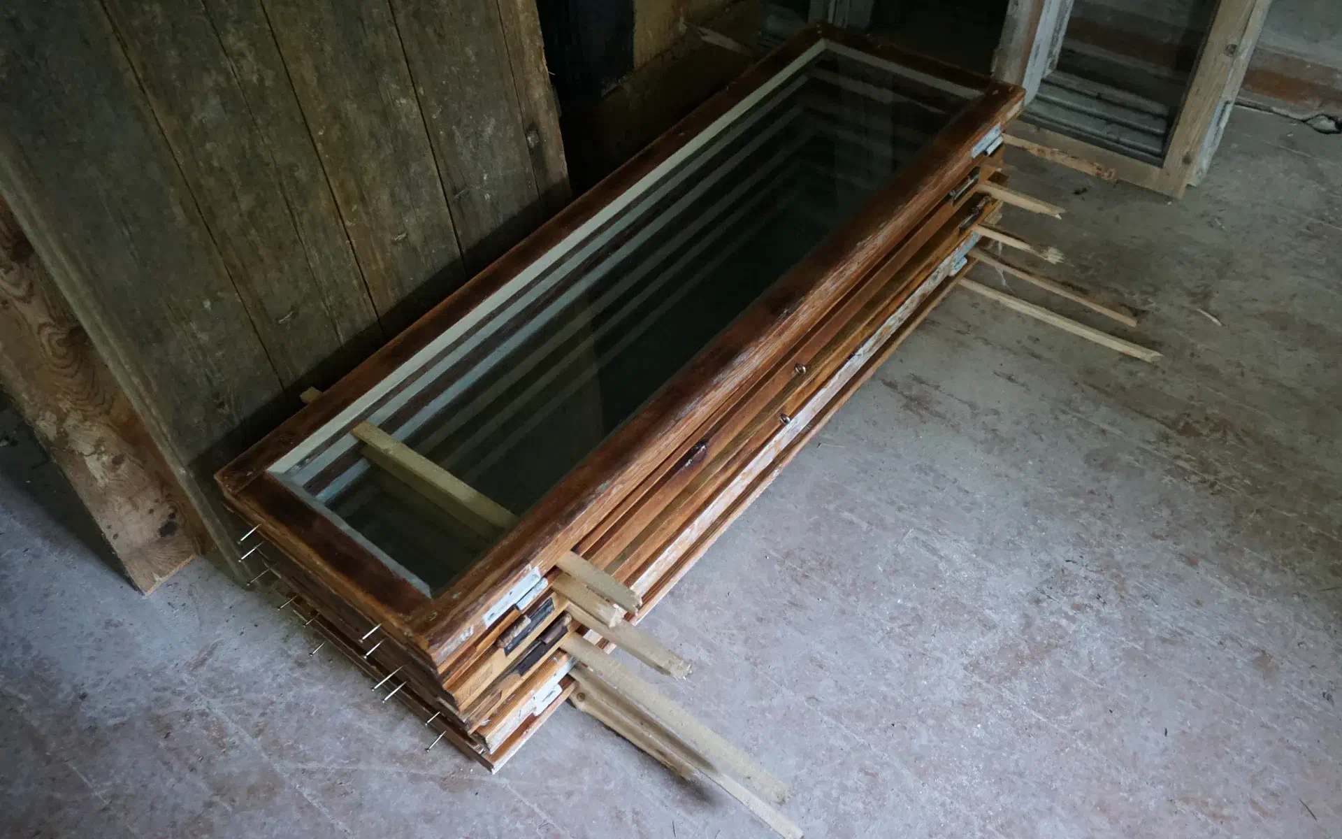A stack of finished windows is left out to dry.