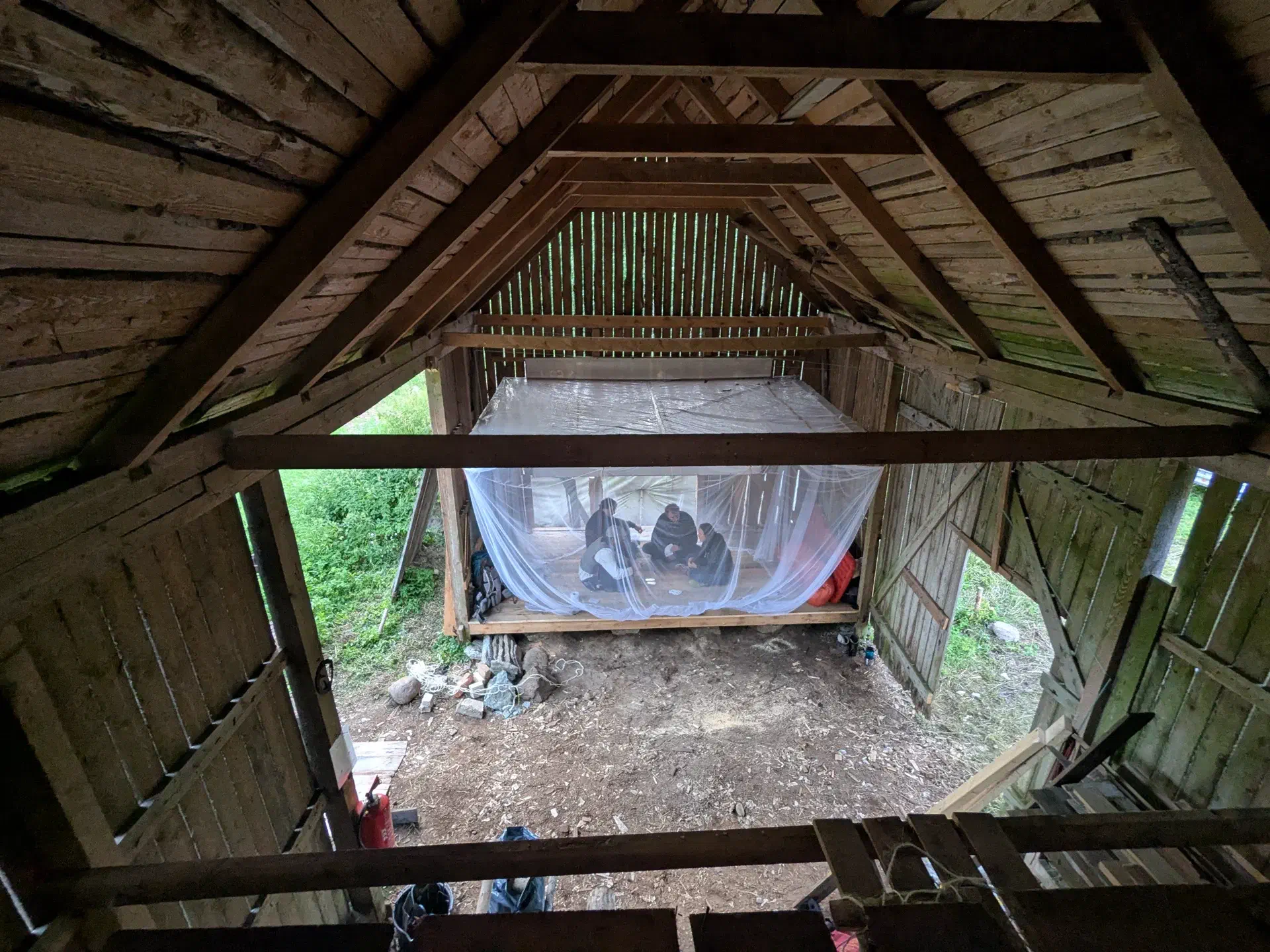From the new, high floor, you can see the mosquito-free zone. People are playing cards there.