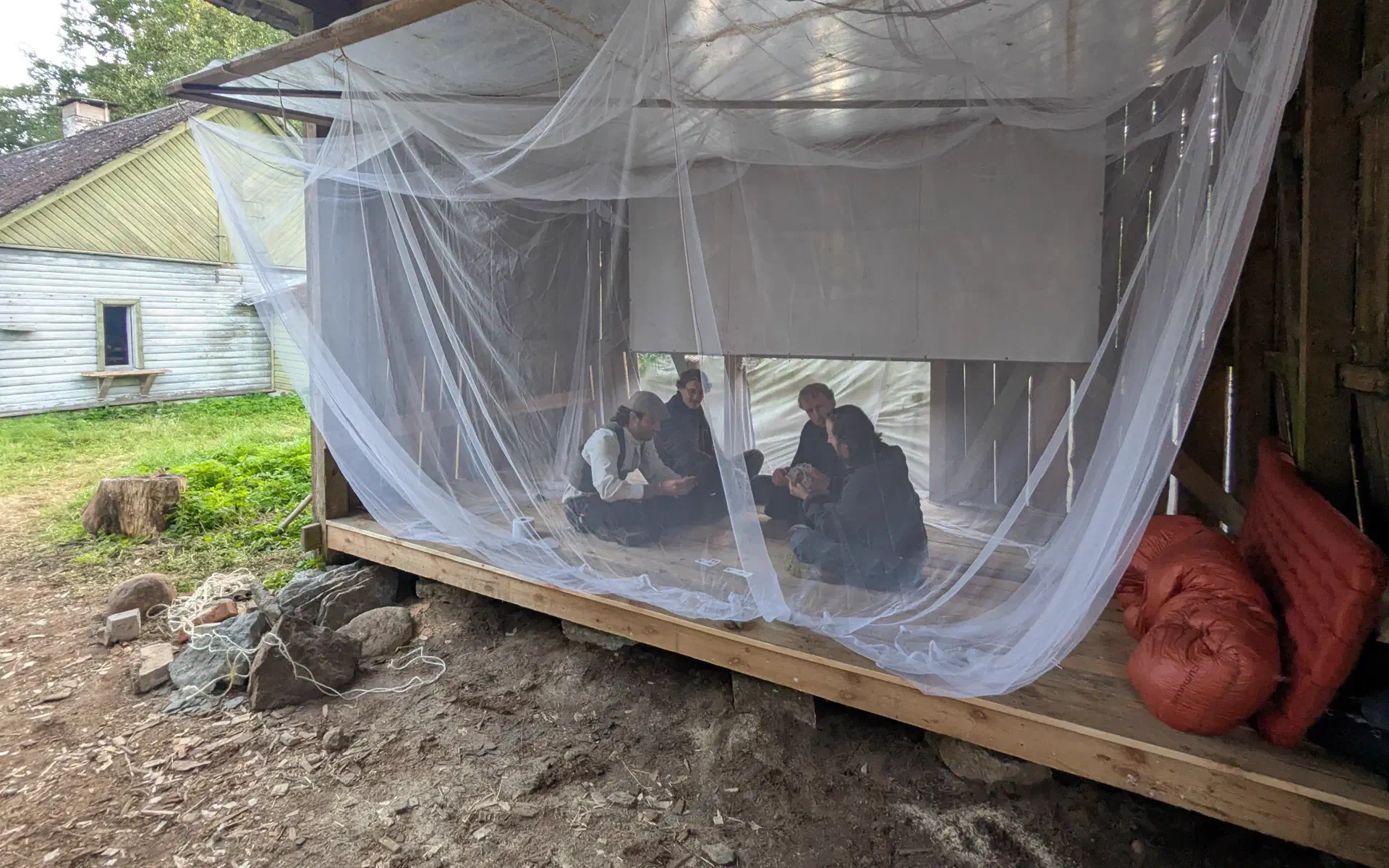 Card games are played in the mosquito-free zone.