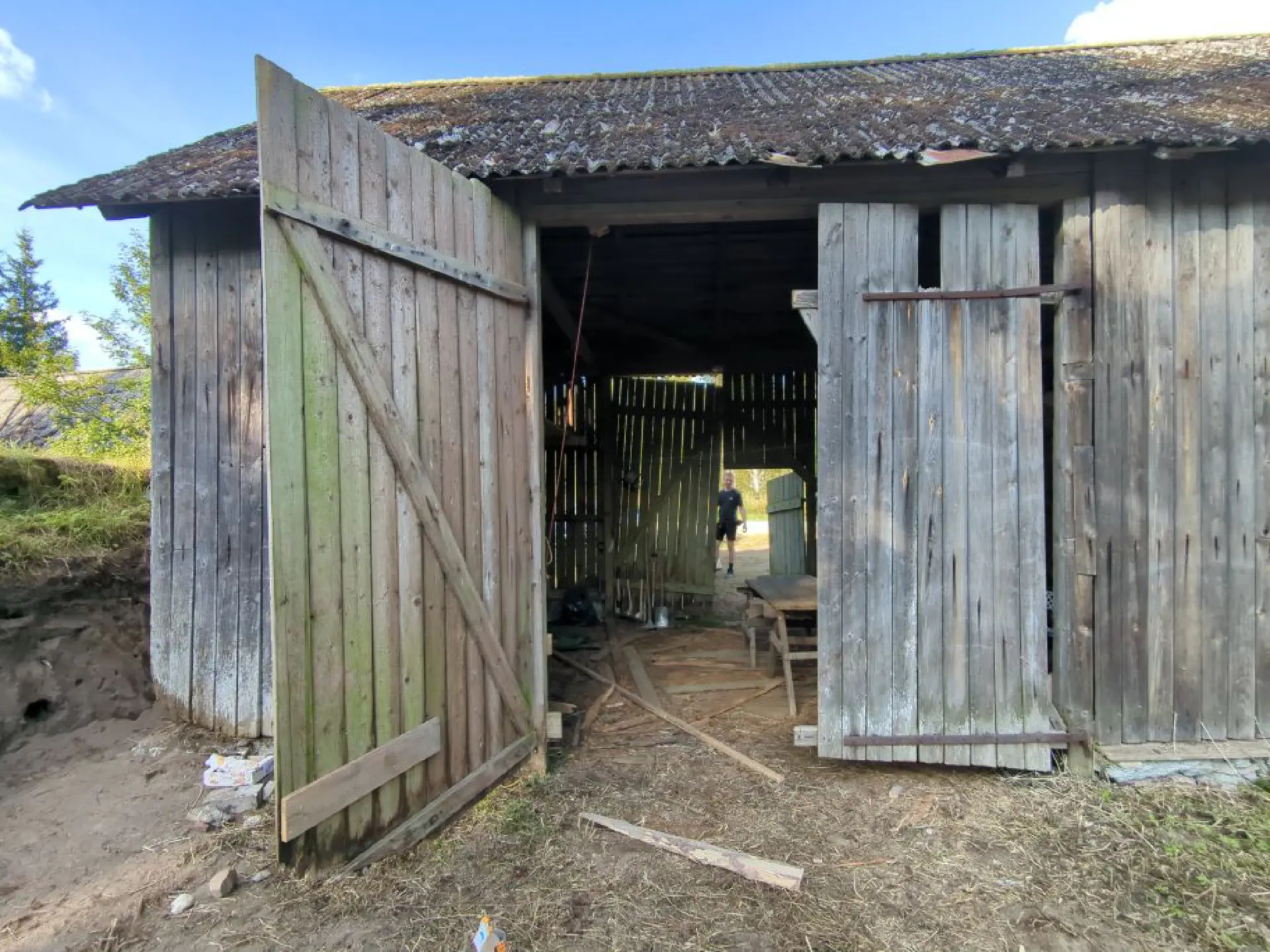 Klaas looks proudly through the barn doors, the gates of which can now stand open again