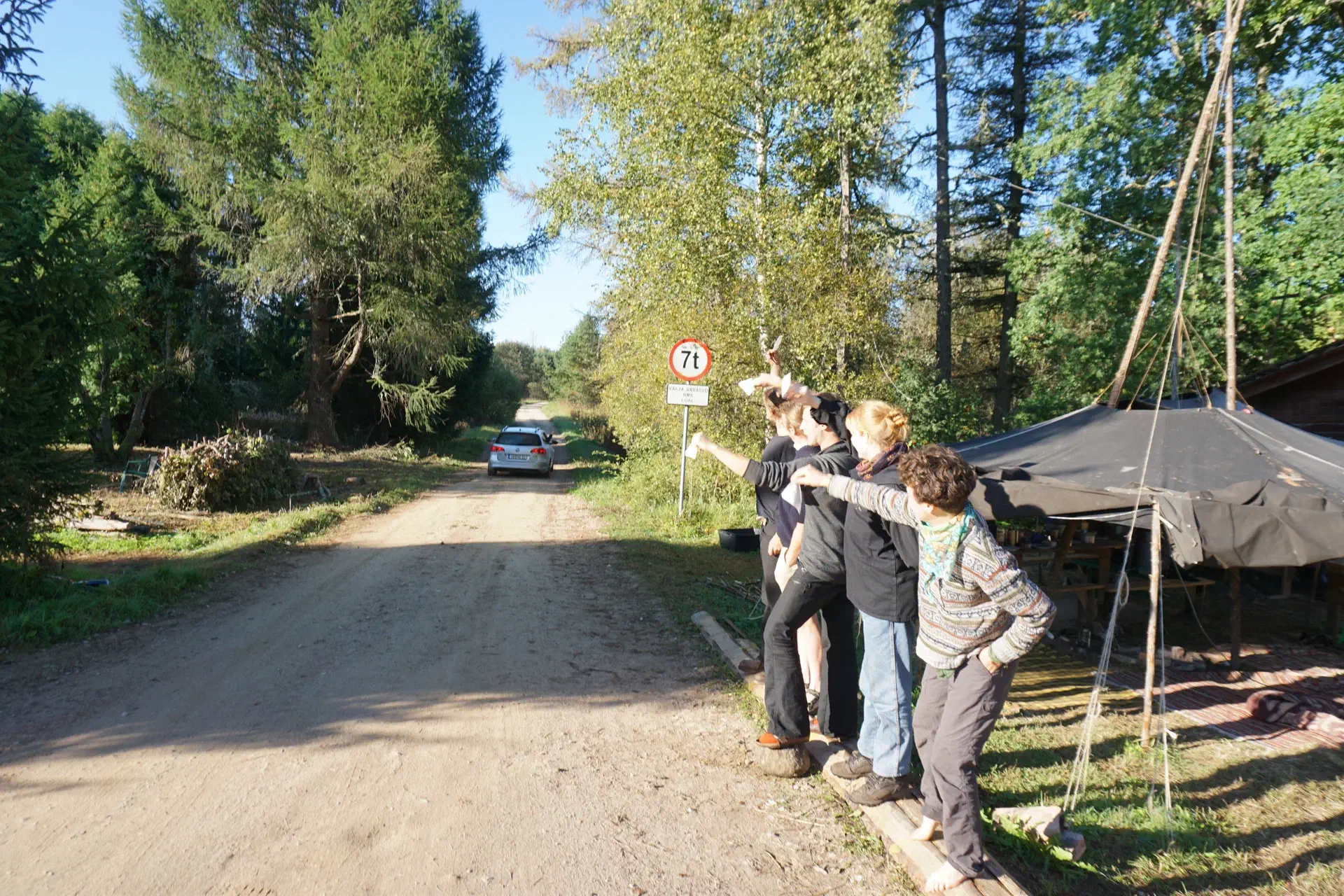 Tobias Passat drives off south into the forest, the rest of the troupe waves paper towels.