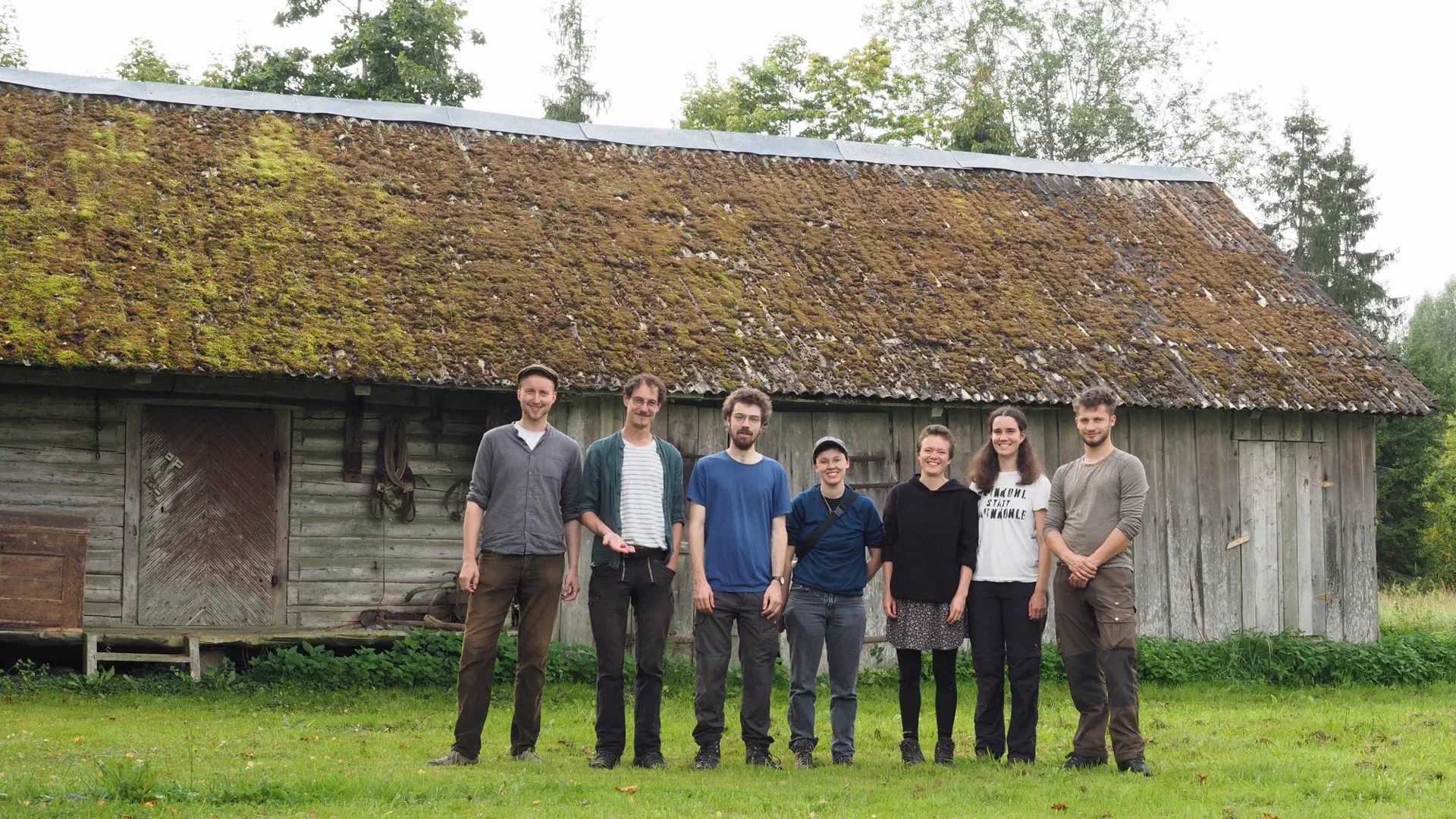 7 people in front of a farm building