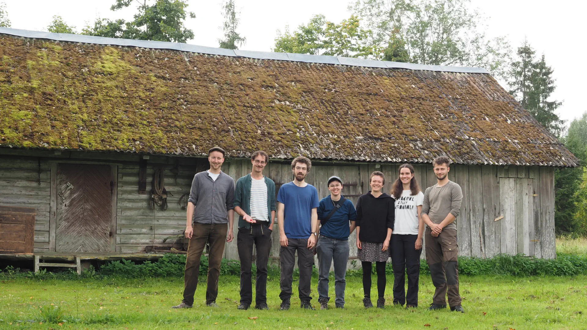 7 people in front of a farm building