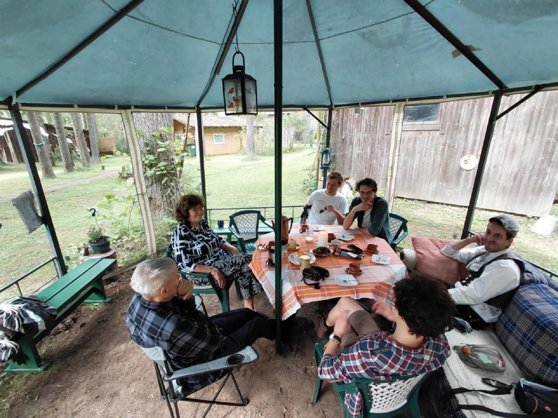 Association members are sitting in Marjus and Jaans mosquito-proof tent and enjoy some coffee and cake