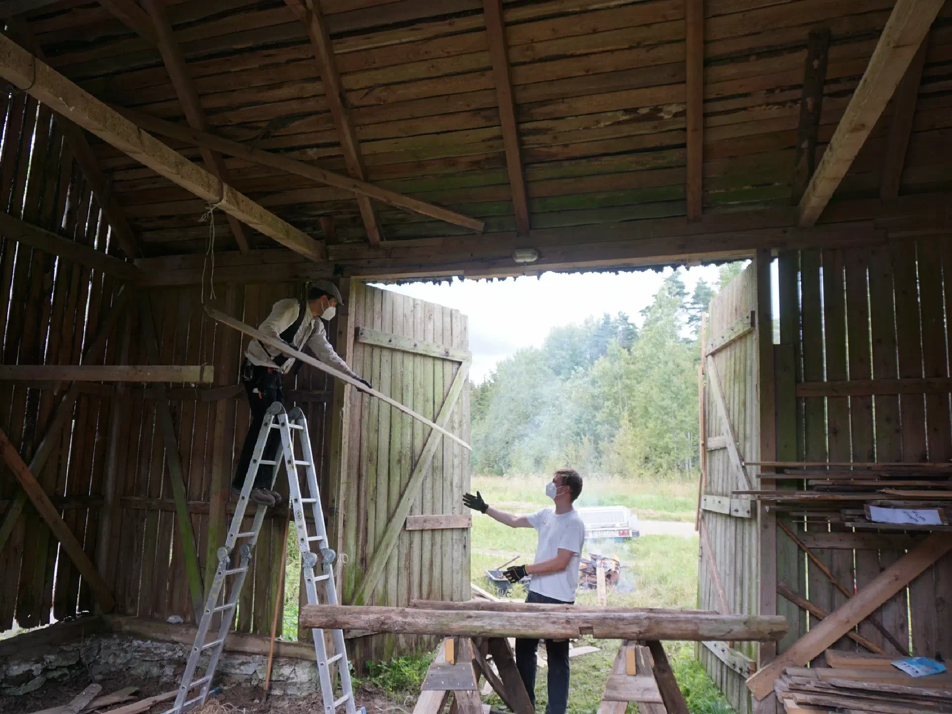 From the ladder, Anton is passing a board to Hagen