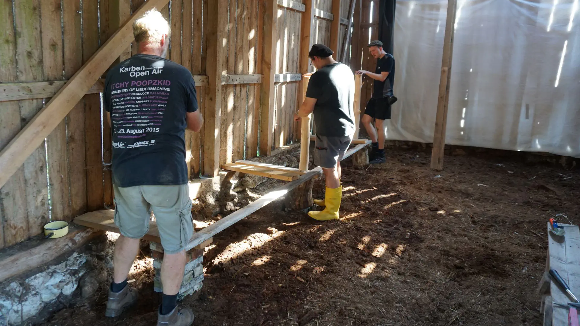 A shelf is built against the barn wall.
