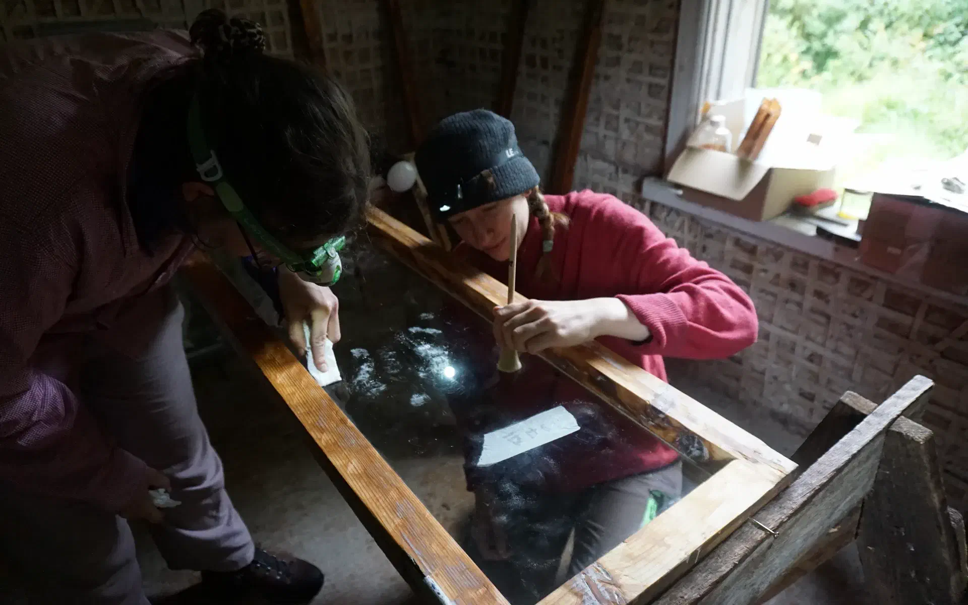 Anne and Jolie are removing window putty from the panes. It got there accidentally.
