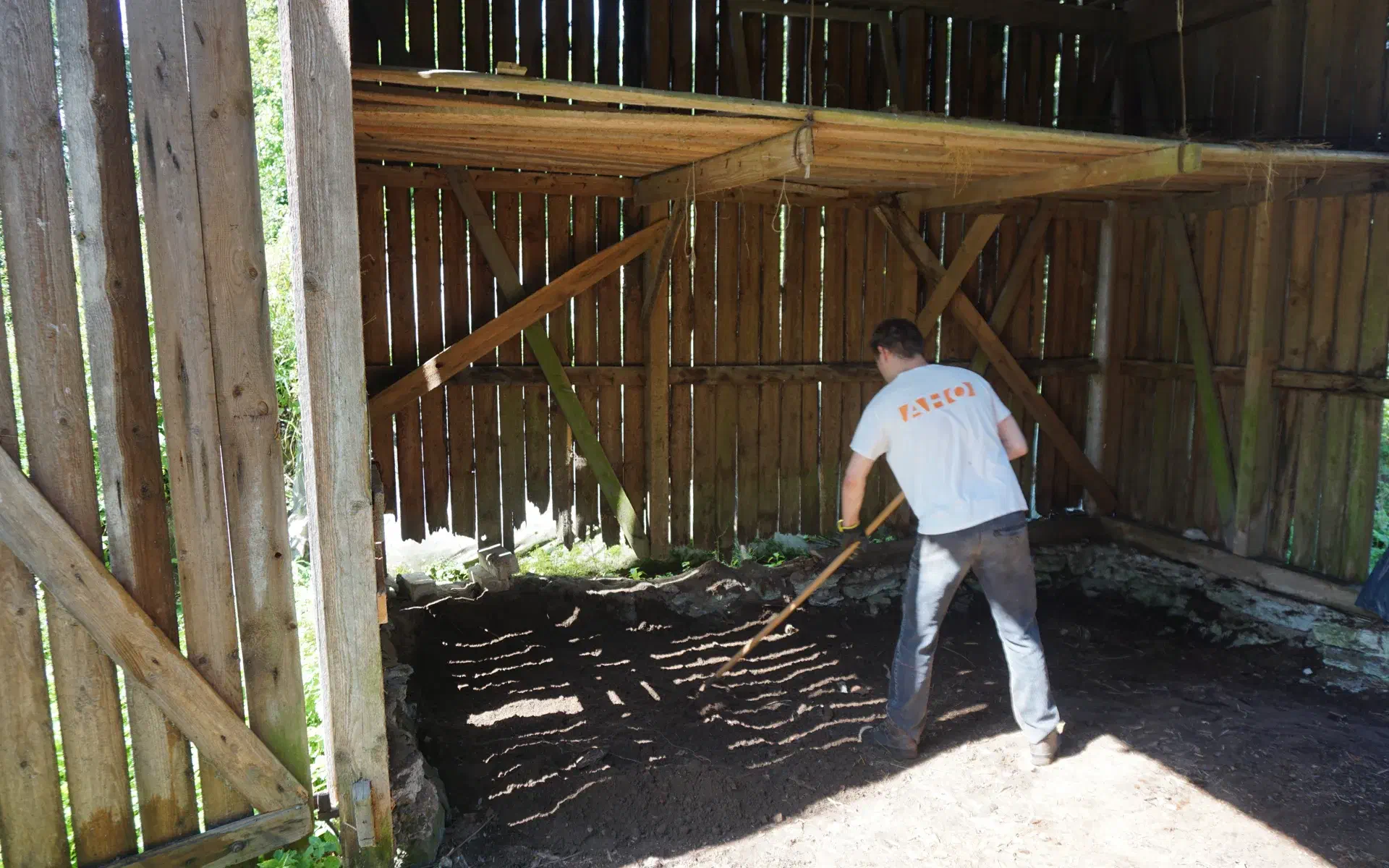 Holes have formed in the back wall of the barn due to weathering.