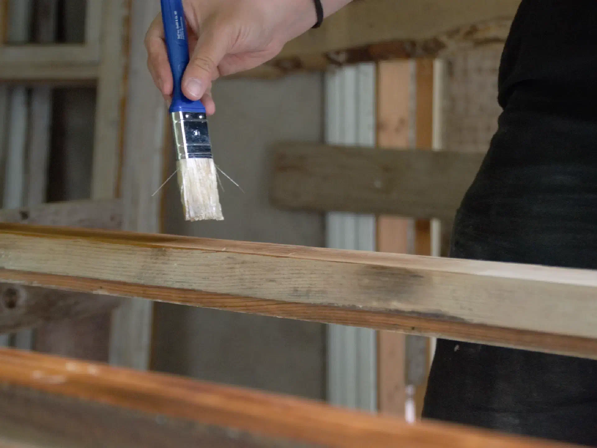A paintbrush and a faintly visible window frame