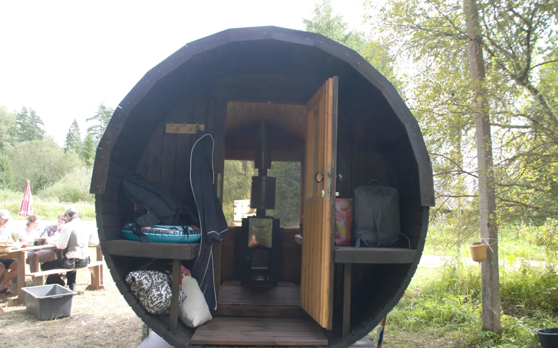 A large, barrel-shaped sauna on a trailer