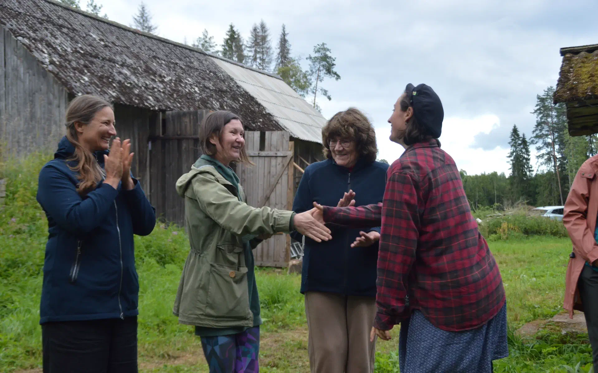 The three potato salad chefs on the winners' podium receive a congratulatory handshake from Anna.