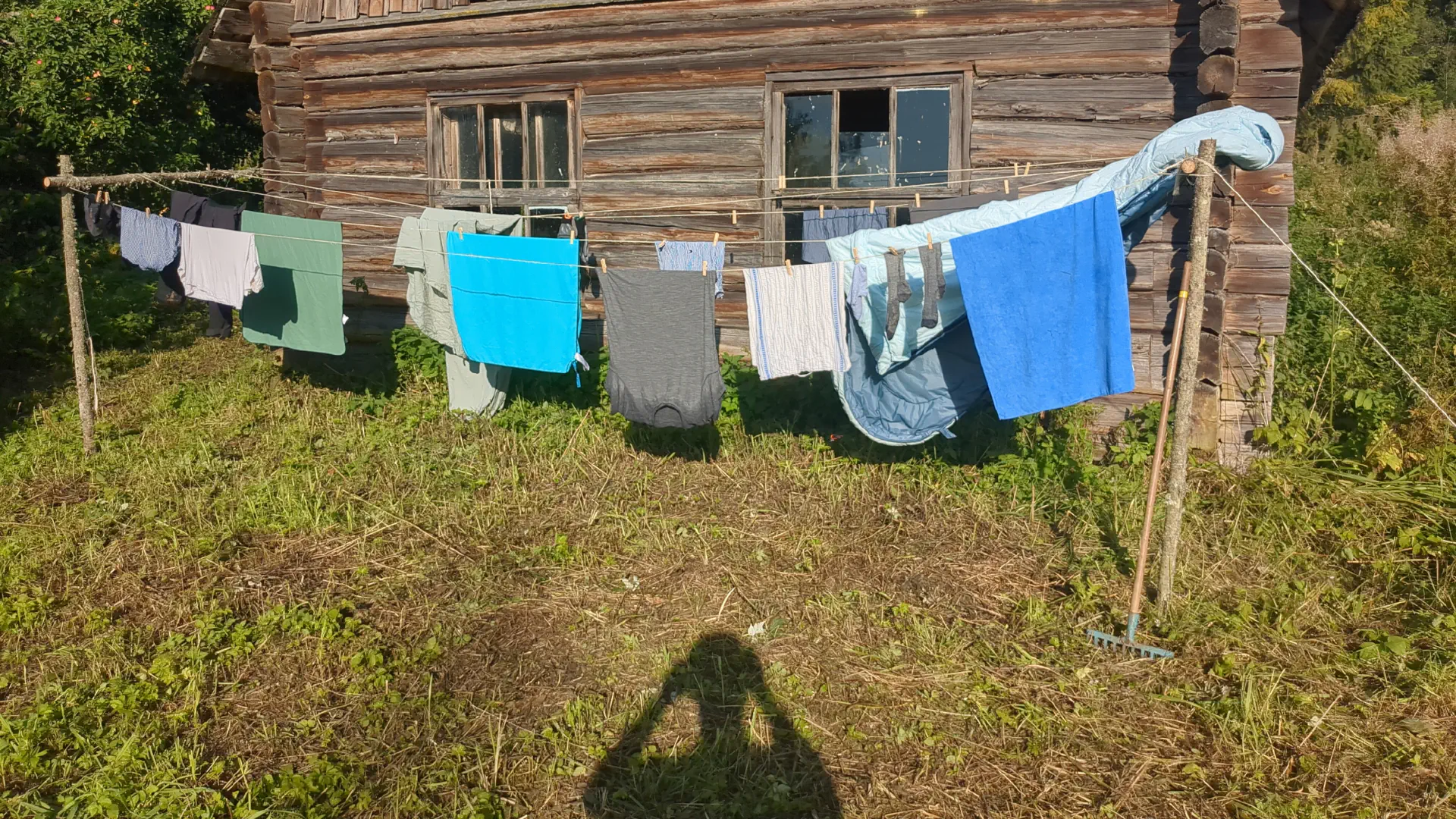 Laundry hangs on the new washing lines in front of the gable end of the barn