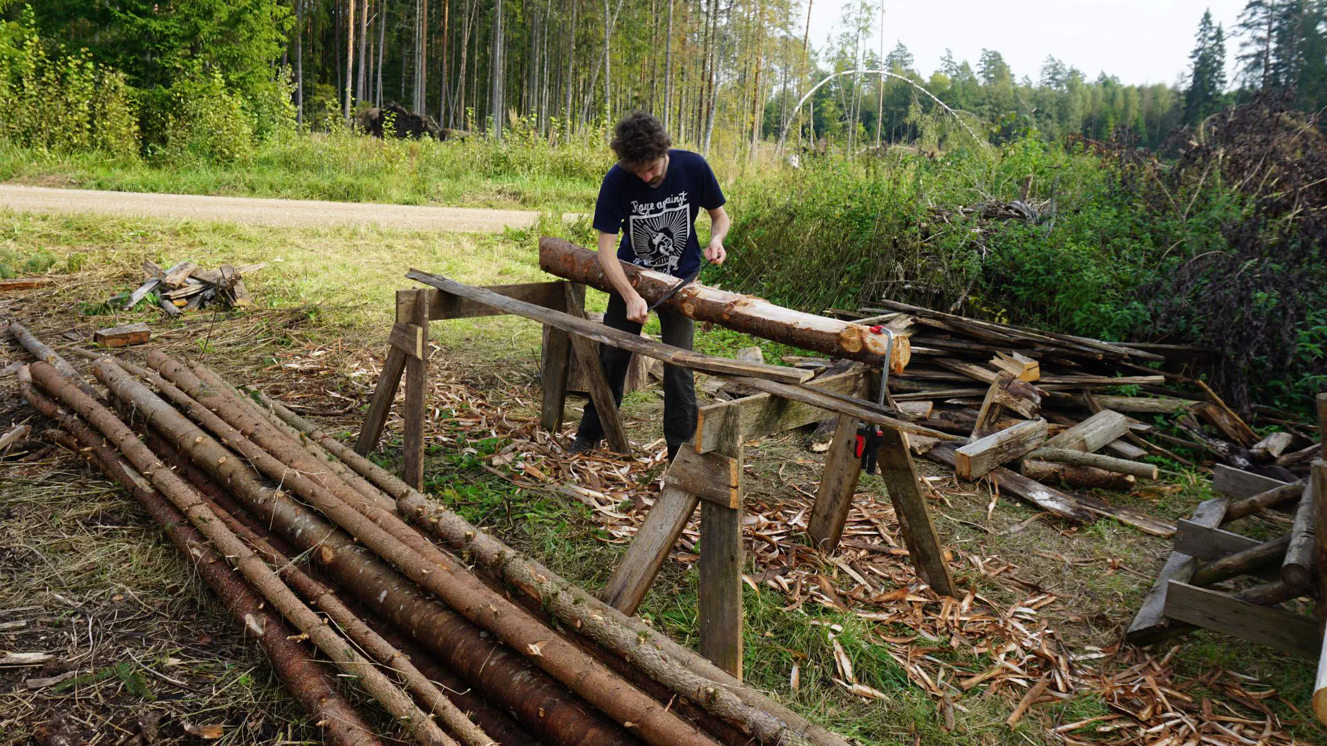 Lionel peels spruce trunks for storing later