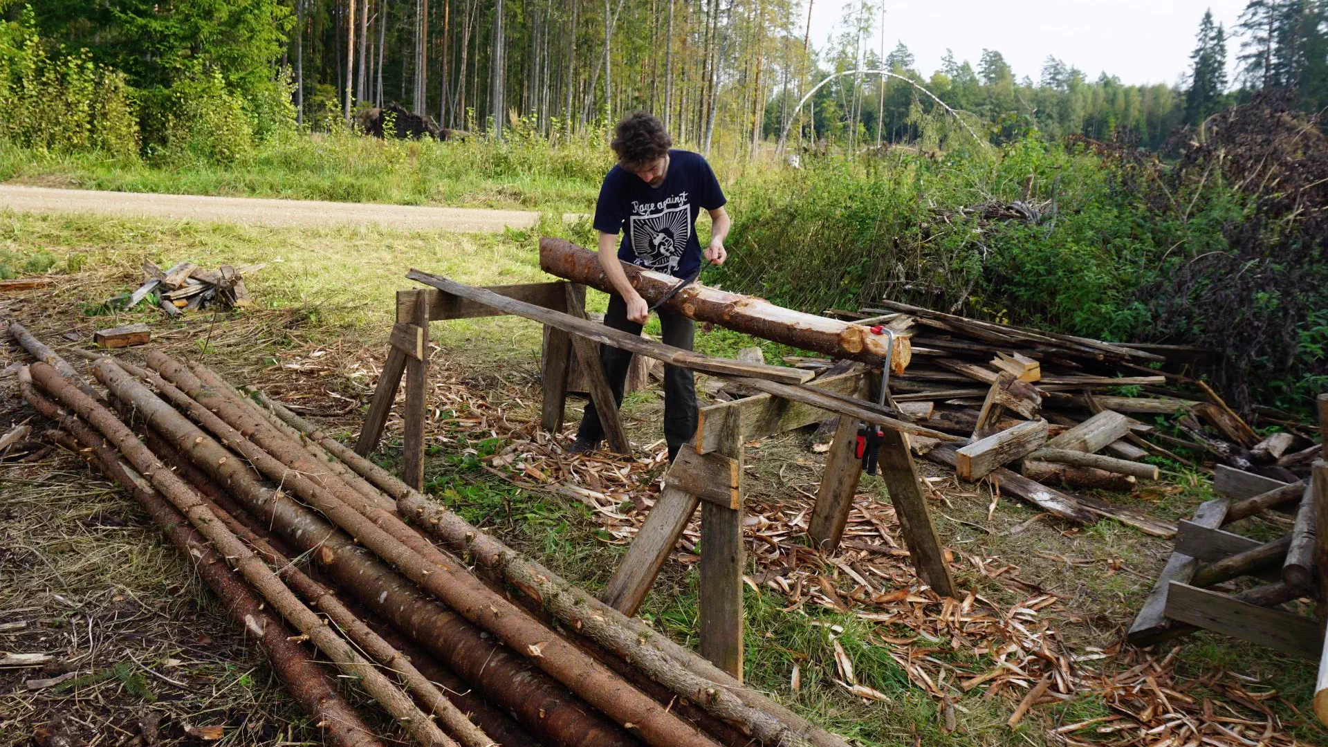 Lionel peels spruce trunks for storing later