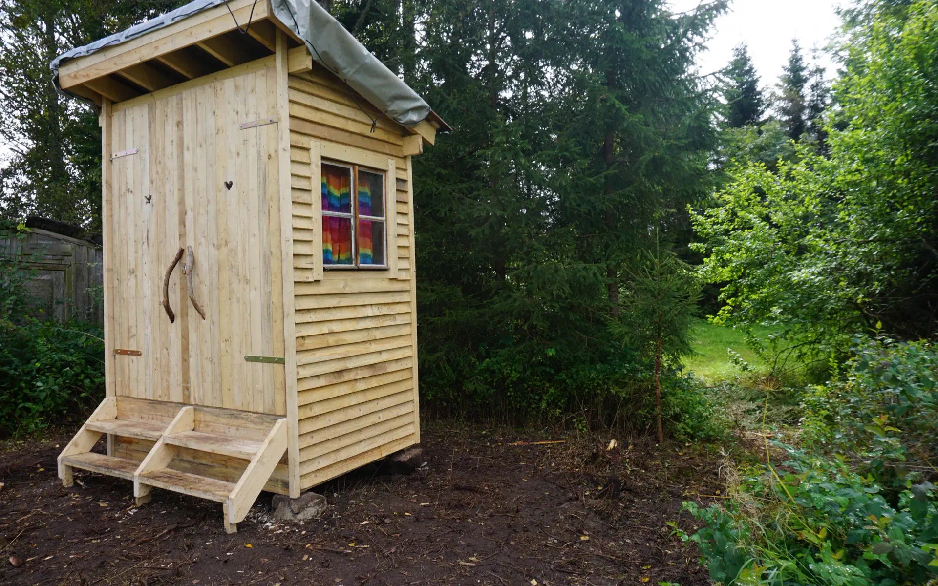 The finished toilet house viewed at an angle from the front