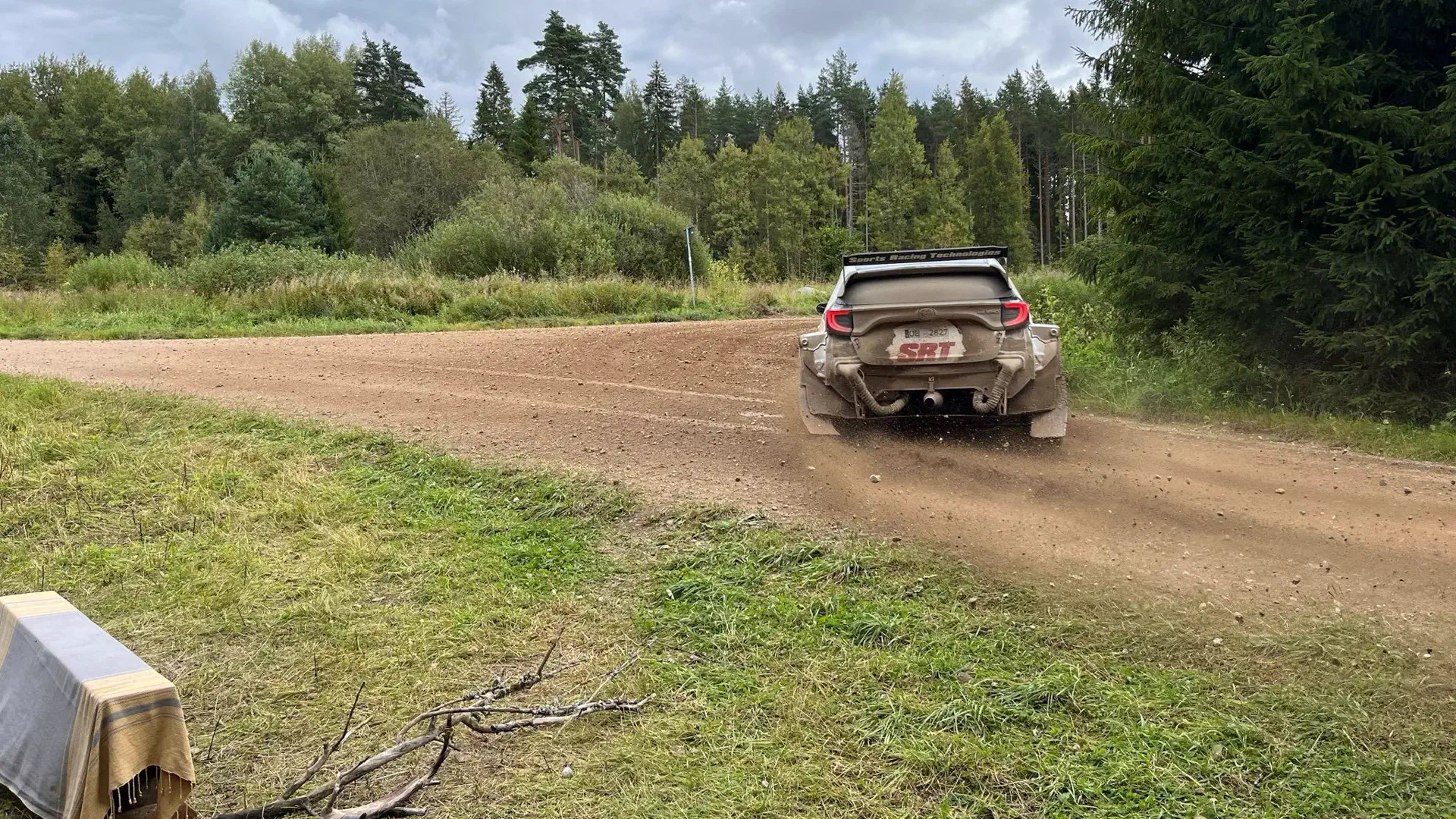 The rally car drifts into the curve.