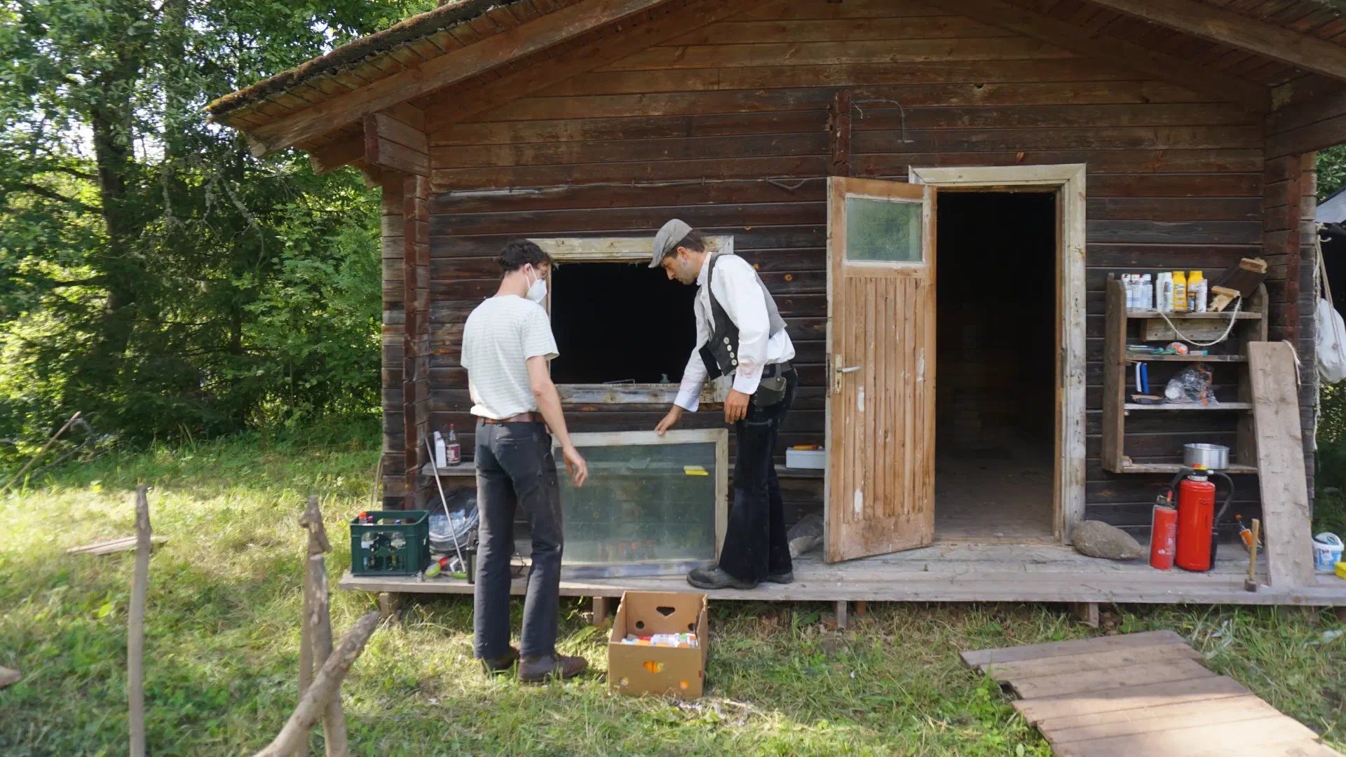 Lukas and Anton are removing the window from the sauna.