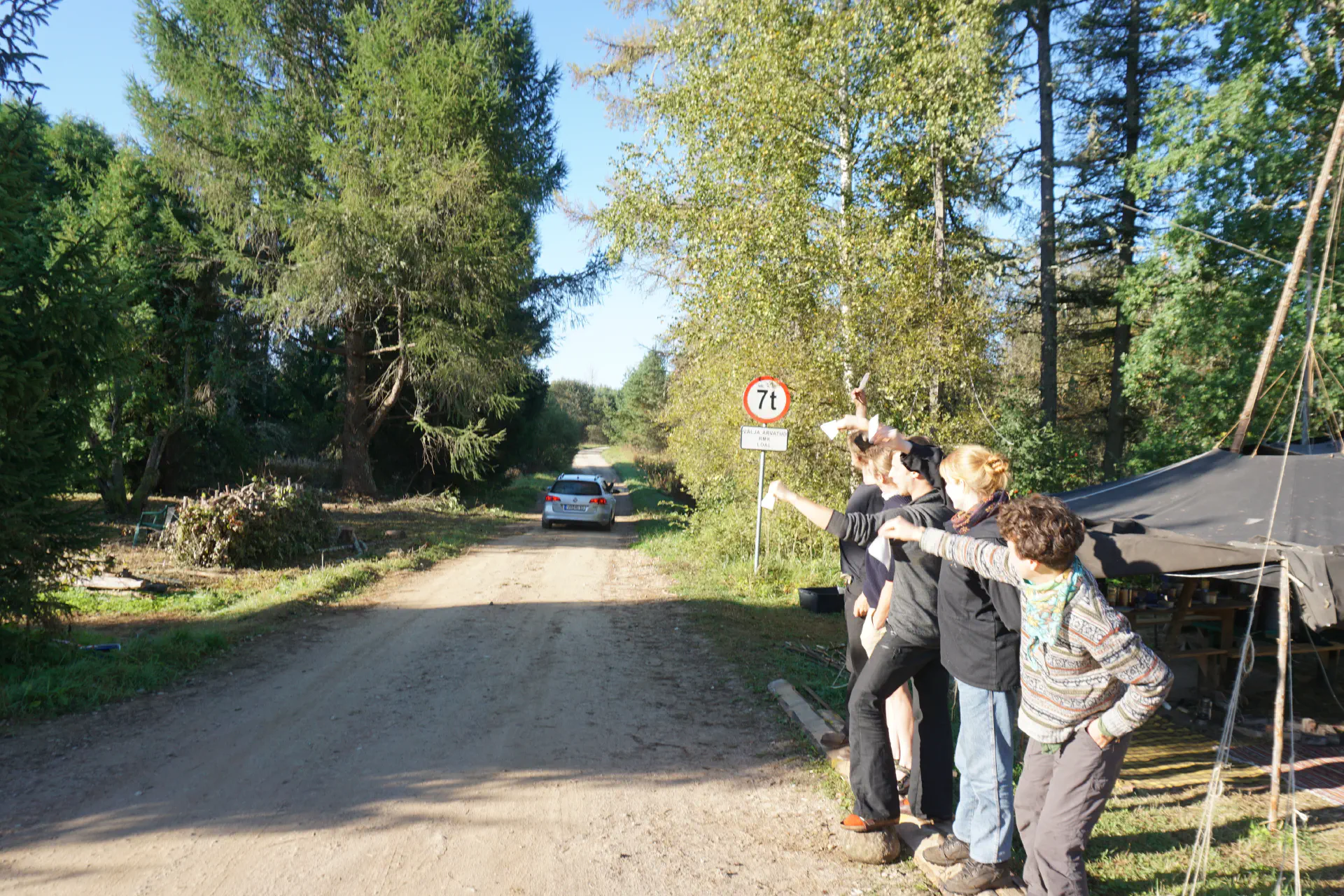 Tobias Passat drives off south into the forest, the rest of the troupe waves paper towels.