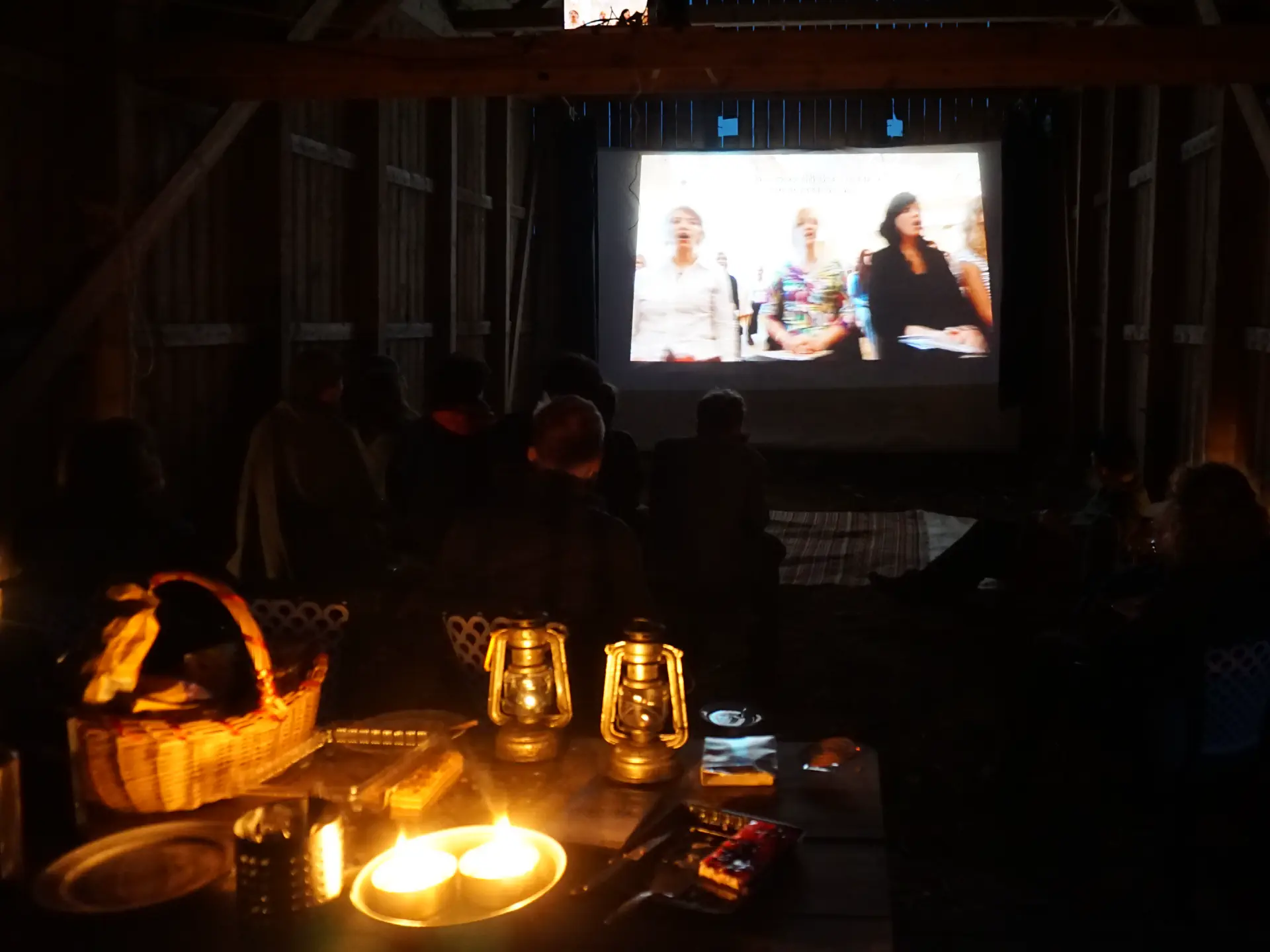 On the screen in the barn, the movie 'The singing revolution' is shown